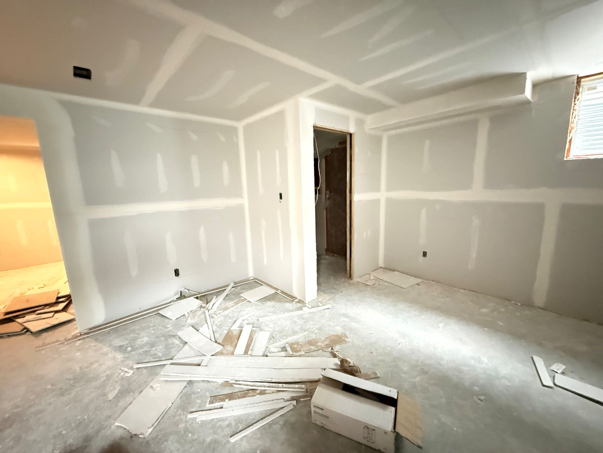 Framed bedroom and den with drywall complete before finishing