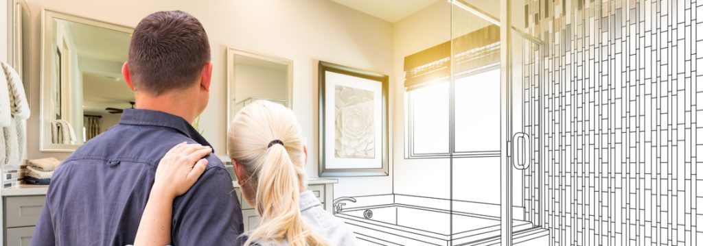a couple looking aat their newly renovated bathroom